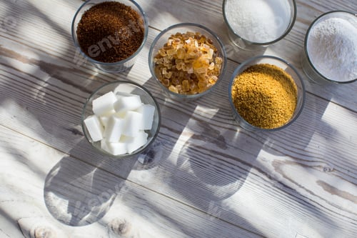 Preview: Glasses of sugar in various forms, overhead view