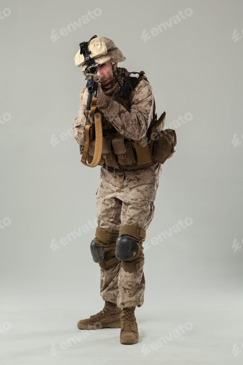 Preview: Military soldier preparing for action in tactical uniform during training session indoors