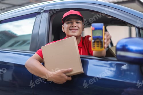 Preview: Portrait Of Deliveryman Inside The Car Smiling While Holding Package Box And Showing Edc Machine
