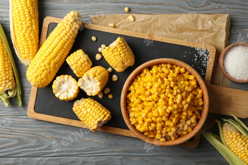 Preview: Composition with fresh raw corn and cutting board on wooden table