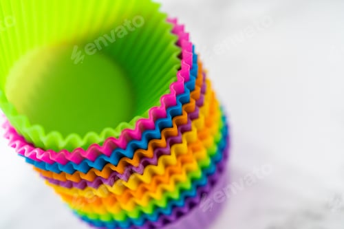 Preview: Stack of Colorful Cupcake Liners on White