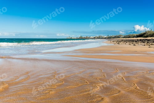 Preview: Beautiful ocean sandy beach nature background with town on the horizon. Ocean tide