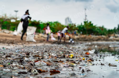 Preview: Blurred of volunteers collecting garbage. Beach environment pollution. Volunteers cleaning the beach