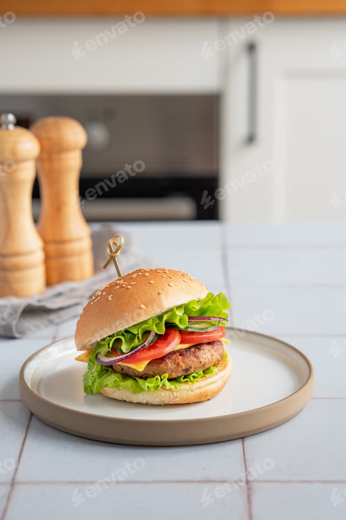 Preview: Meat burger with tomato, cheese, and lettuce on a plate on a table with spice