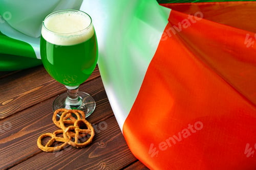 Preview: Glass of green beer against flag of Ireland
