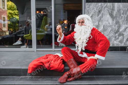 Preview: santa claus holds sparklers in her hands