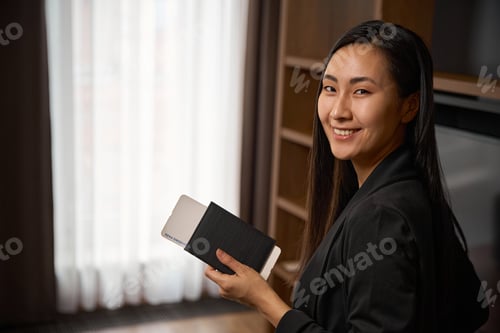 Preview: Young woman holds a ticket in her hands