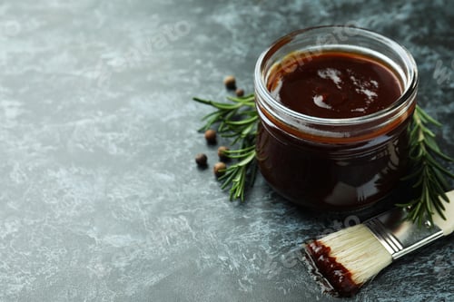Preview: Barbecue sauce, spices and brush on black smoky background
