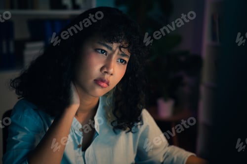 Preview: business woman have a neck pain because using the computer and working for a long time at night.