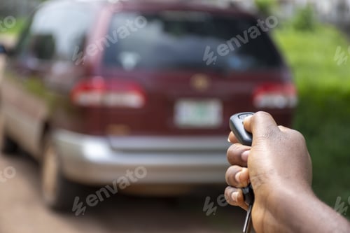 Preview: Black person using a car remote to unlock a car
