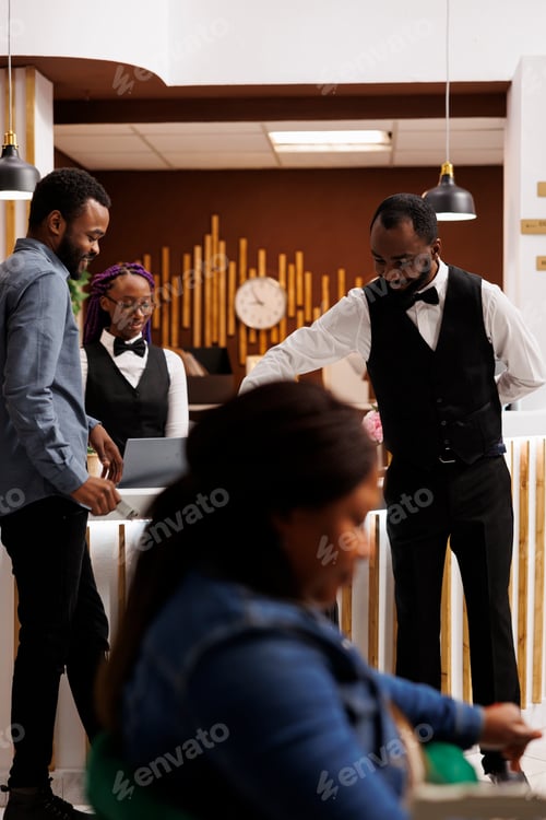 Preview: Hotel bellboy helping guest with luggage