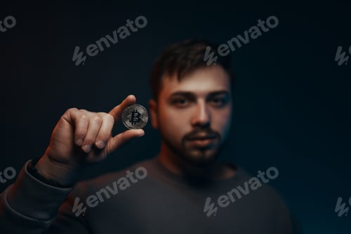 Preview: Man holding bitcoin. Financial ecosystem. The currency of the future.