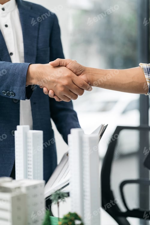 Preview: Close up shake hands, Considering buying a home, investing in real estate.