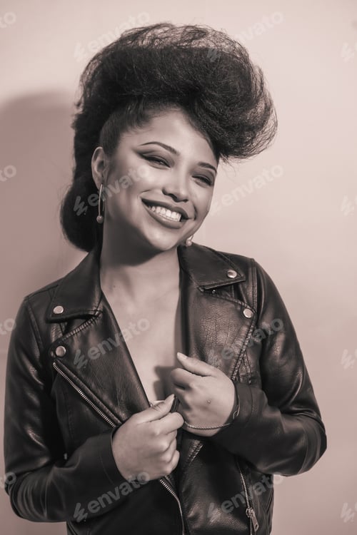 Preview: A closeup grayscale portrait of a funky stylish woman in a leather jacket posing indoors