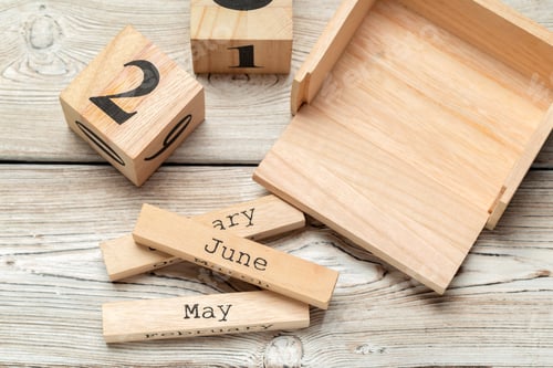 Preview: top view of parts of wooden calendar on dark wooden tabletop