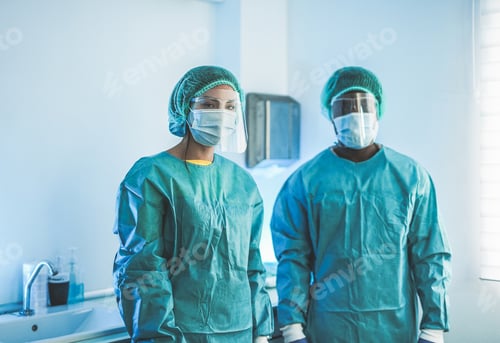 Preview: Multiracial medical workers wearing hazmat suit and protective face masks inside hospital