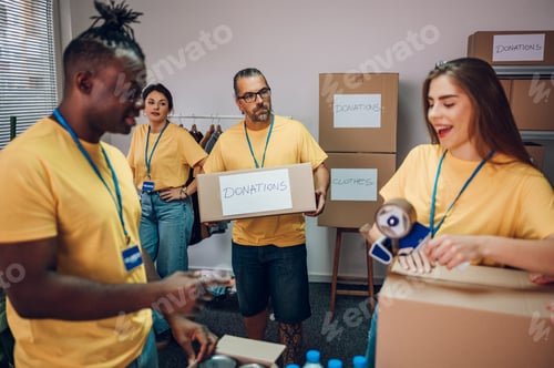 Preview: Group of multiracial volunteers working in community charity donation center