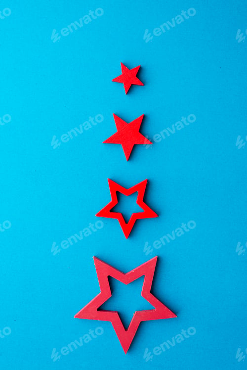 Preview: Red Star Shapes on Blue Background in Vertical Row
