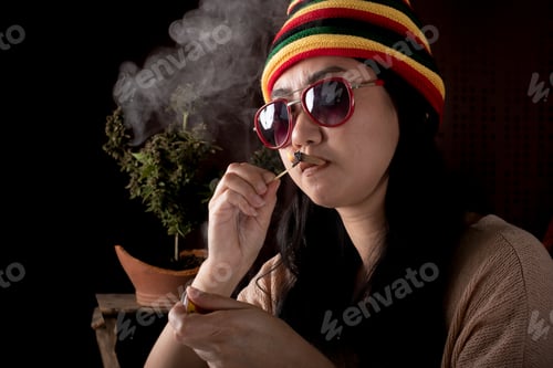 Preview: Beautiful Asia women smoking weed at cannabis tree background