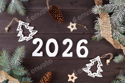 Preview: The numbers 2026 on a dark wooden background with fir branches and cones