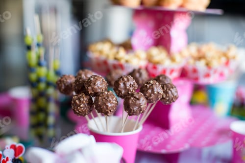 Preview: Chocolate cakepops on holiday dessert table at kid birthday party