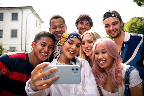 Preview: Group of multiethnic teenagers spending time outdoor and having fun