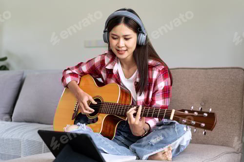 Preview: Young woman is playing guitar and practice to singing the song w