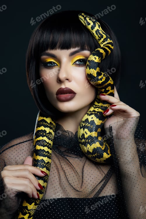 Preview: Beauty woman short haircut python yellow snake on her neck. A yellow snake on the shoulders