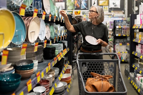 Preview: Shopping for dinnerware in a home goods store during a busy afternoon
