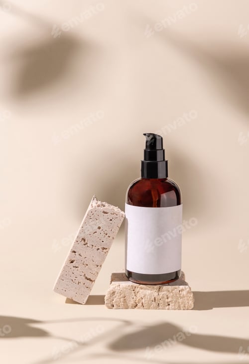 Preview: Glass cosmetic one pump bottle on stone on light beige, hard shadows. Label Mockup