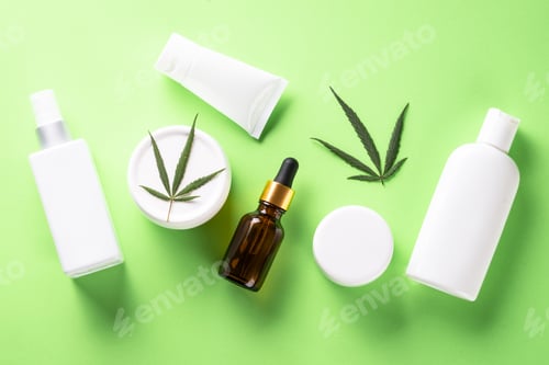 Preview: Cannabis cosmetic products on green background top view.