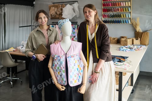 Preview: Portrait of Two Young Women Smiling While Designing Patchwork Garment