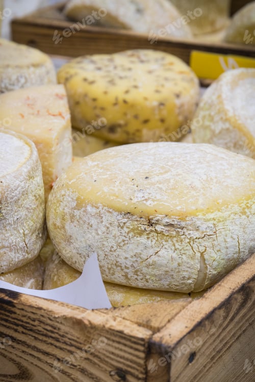 Preview: Blocks of cheese with spices for sale on stall or in grocery shop