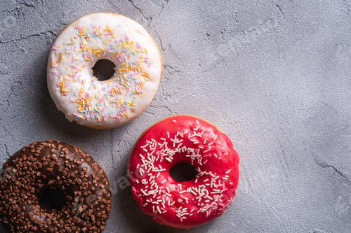 Preview: Delicious Donuts with Sprinkles on Grey Surface