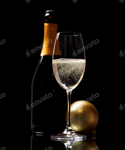 Preview: Champagne glass and bottle on a black