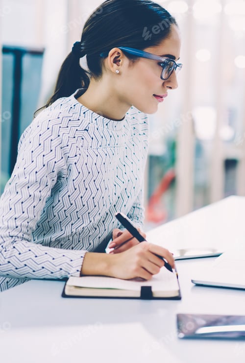 Preview: Smiling woman working at office using technology