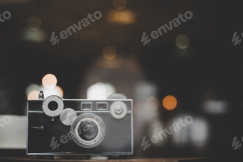 Preview: Vintage or retro camera on wooden table at cafe.
