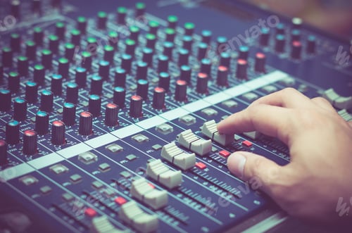 Preview: Hand adjusting audio mixer