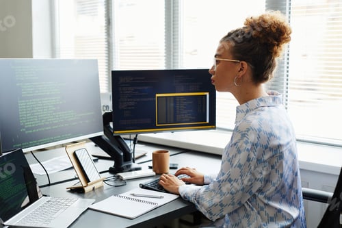 Preview: Female IT specialist writing codes on computer