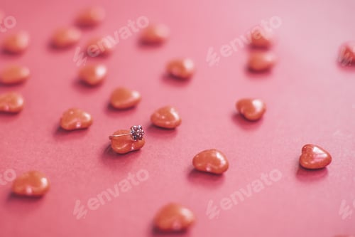 Preview: Engagement Ring with Candy Hearts on Pink Background