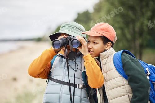 Preview: Two Preteen Boys Exploring Nature Together Using Binoculars Outdoors