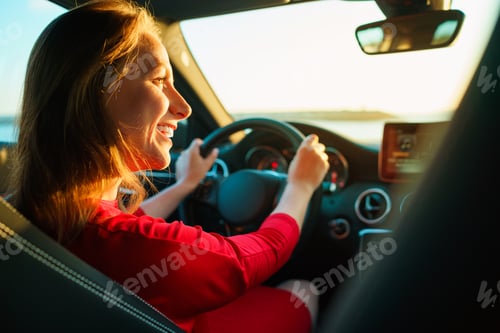 Preview: Happy woman in red dress driving car
