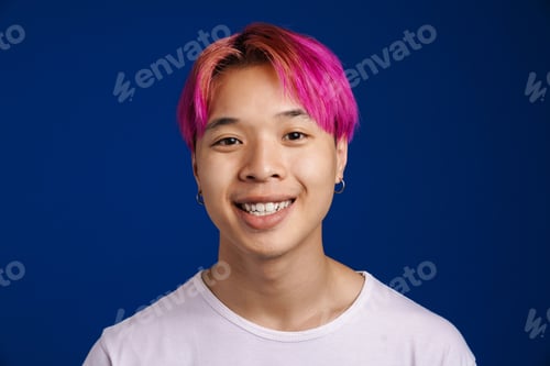 Preview: Asian boy with pink hair smiling and looking at camera