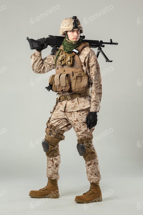 Preview: Soldier in military uniform poses with weapon on studio background