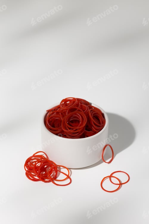 Preview: Red Rubber Bands in a Bowl on White