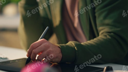 Preview: Closeup creator hand drawing tablet in modern office. Artist man staring monitor
