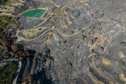 Preview: Drone aerial of burned hillsides and blackened earth stretch after wildfires.