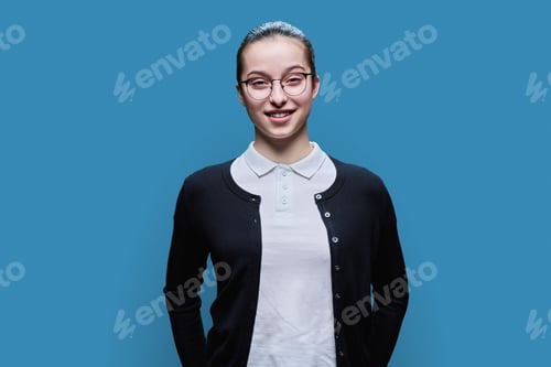 Preview: Portrait of happy high school student girl on blue background