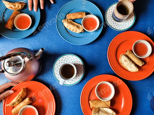 Preview: Overhead food flat lay in Thai restaurant on blue tablecloth.