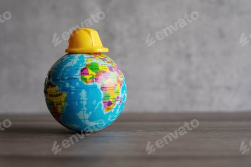 Preview: Hard hat on top of world globe.